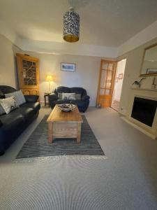 a living room with a couch and a coffee table at Heligog at Deanfield House Moelfre Sea view adult only appartment in Moelfre in Moelfre
