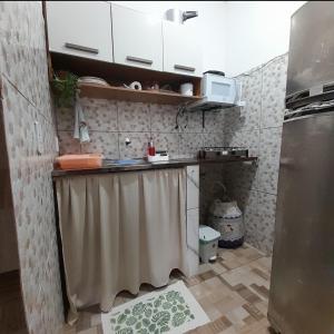 a small kitchen with a sink and a shower curtain at Meu refúgio 01 in Belém