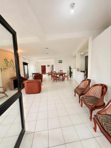 a lobby with chairs and tables and a waiting room at Athula Beach Front Hotel Hikkaduwa in Hikkaduwa +8 photos