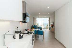 a kitchen with white countertops and a dining room at Apartment Playa del Aguila NE/IM in Playa del Aguila