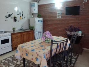 a kitchen with a table with a table cloth on it at Cabañas Sprinter in Trapiche +9 photos