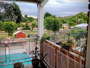 a balcony with a view of a yard at Cabañas Sprinter in Trapiche