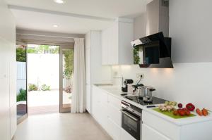 a kitchen with white cabinets and a counter top at Apartment Playa del Aguila NE/IM in Playa del Aguila