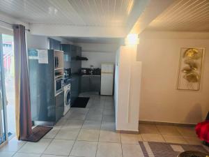 a kitchen with a refrigerator and a stove at Chez Pascal in Terre-de-Haut
