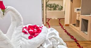 a bunch of red roses in a white towel at Pooh Beach Resort & Spa in Jomtien Beach