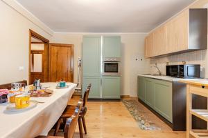 a kitchen with a table and chairs in a room at Casa Ai tre cavalli vista sulle Dolomiti in Val di Zoldo