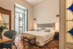 Un ou plusieurs lits dans un hébergement de l'établissement Hotel Boutique Casa de Colón
