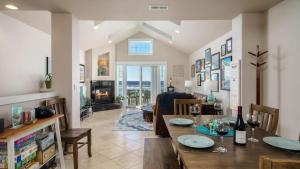 a dining room and living room with a dining table at Moonlight by AvantStay Modern Home w Views Direct Access to Rockaway Beach in Rockaway Beach