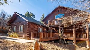 a log cabin with a porch and a deck at Hot Tub Fire Pit Game Room Large Deck Views Angels Camp Lodge by AvantStay in Big Bear Lake