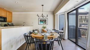 a kitchen and dining room with a table and chairs at Marillac by AvantStay Gorgeous Ski Cabin w Balcony Patio in Olympic Valley
