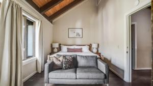 a bedroom with a bed and a chair at Marillac by AvantStay Gorgeous Ski Cabin w Balcony Patio in Olympic Valley