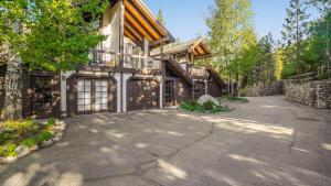 a large house with a driveway in front of it at Marillac by AvantStay Gorgeous Ski Cabin w Balcony Patio in Olympic Valley