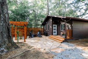a small cabin with a patio and a tree at Tranquil Mountain Retreat in Santa Cruz in Santa Cruz