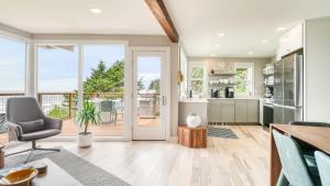 a kitchen with a door leading to a patio at Sunset Cove by AvantStay Beachfront w Balcony in Arch Cape