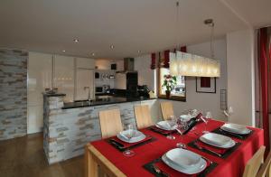 a dining room table with a red table cloth at Landhaus Alpenflair Whg 310 in Oberstdorf