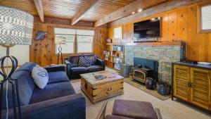 a living room with a couch and a fireplace at Aster by AvantStay Classic Kings Beach Cottage In The Of North Shore in Kings Beach