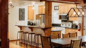 a kitchen with a table and chairs and a refrigerator at Aster by AvantStay Classic Kings Beach Cottage In The Of North Shore in Kings Beach