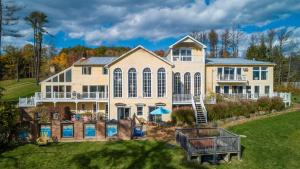 a large house with a swimming pool in the yard at River House by AvantStay Historic Secluded Estate on the Hudson River w Pool Sleeps 24 in Hudson