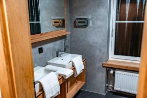 a bathroom with a sink and a mirror at Hotel Rad in Leutkirch im Allgäu +31 photos