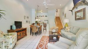 a living room with a couch and a table at Key West Found by AvantStay Close to Shops w Patio Shared Pool Week Long Stays Only in Key West