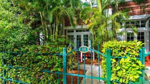 a blue fence with a number on it in front of a house at Key West Found by AvantStay Close to Shops w Patio Shared Pool Week Long Stays Only in Key West
