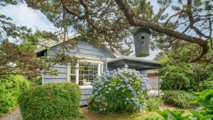 a house with a bird house on top of it at Beach Pines Bungalow by AvantStay Classic Cottage Steps to the Beach w Private Yard in Arch Cape