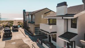 an aerial view of a house and the beach at ONeill I by AvantStay Coastal Paradise Steps from Beach Modern Decor in Newport Beach