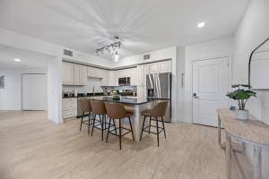 a kitchen with a table and chairs in a room at Luxury Condo with Sanctuary Views Merritt Island in Audubon