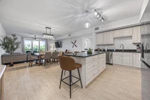 a kitchen and dining room with a table and chairs at Luxury Condo with Sanctuary Views Merritt Island in Audubon +21 photos