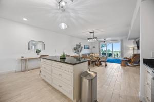 an open kitchen and living room with a dining room at Luxury Condo with Sanctuary Views Merritt Island in Audubon