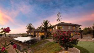 a house with a tennis court in front of it at Sangiovese By AvantStay Spectacular Estate w Pool Hot Tub Putting Green in Temecula
