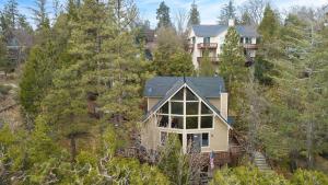 an aerial view of a house in the woods at North Bay by AvantStay Chic Retreat w Peloton in Blue Jay