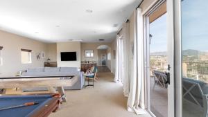 a living room with a couch and a pool table at Palazzo Del Sol By AvantStay Breathtaking Home w Mountain Views Hot Tub in Temecula