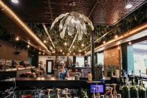 a person standing behind a bar in a restaurant at DayDreamer Domes in South Haven