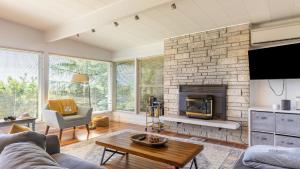 a living room with a couch and a fireplace at Sunny Side Island Retreat by AvantStay Backyard in Freeland