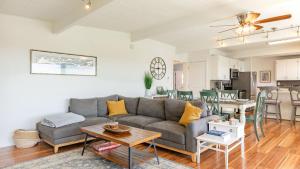 a living room with a couch and a table at Sunny Side Island Retreat by AvantStay Backyard in Freeland