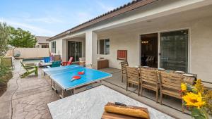 a patio with a blue table and some chairs at Kaleidoscope by AvantStay Colorful Escape Pool in Indio
