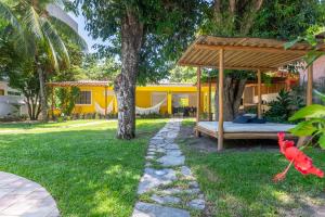 a backyard with a bed and a pergola at Casa a 100 metros do mar- no Centro de Porto de Galinhas in Porto De Galinhas