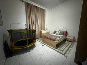 a bedroom with a bed and a large window at Stylish 2 Bedroom with 2 outside area in Abu Dhabi