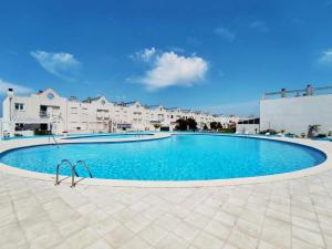 a large swimming pool in front of some buildings at Praia da Barra Sweet Home in Gafanha da Nazaré