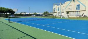 a tennis court in front of a building at Praia da Barra Sweet Home in Gafanha da Nazaré