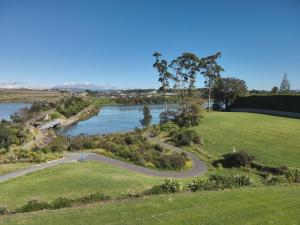 an aerial view of a river and a park at Kotuku Cottage in Tauranga