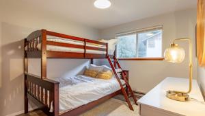 a bedroom with two bunk beds and a desk at Whidbey Bliss by AvantStay 2min to Beach View in Greenbank