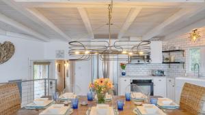 a dining room with a table and a chandelier at Sanctuary by the Sea by AvantStay Waterfront Views in Arch Cape
