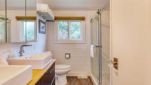 a bathroom with a sink and a toilet and a shower at Sanctuary by the Sea by AvantStay Waterfront Views in Arch Cape +21 photos