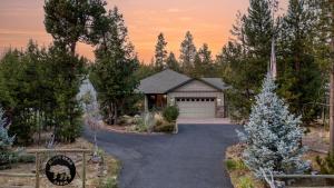 a house with a driveway leading to a garage at Hot Tub Air Hockey Foosball Deck Lounge Near Sunriver Mt. Bachelor Skiing in Bend