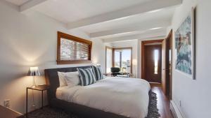 a bedroom with a bed and a window at Modern Love by AvantStay Serene Home in Arch Cape w Large Yard in Great Location in Arch Cape