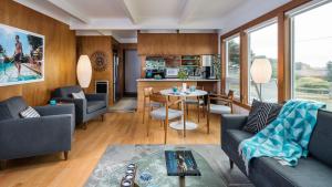 a living room with two couches and a table at Modern Love by AvantStay Serene Home in Arch Cape w Large Yard in Great Location in Arch Cape