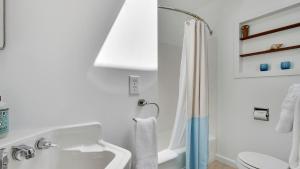 a white bathroom with a sink and a shower at Modern Love by AvantStay Serene Home in Arch Cape w Large Yard in Great Location in Arch Cape +17 photos