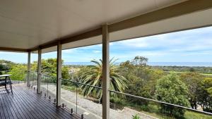 a balcony with a view of the ocean at Ocean Views on Lyrebird in Lakes Entrance
